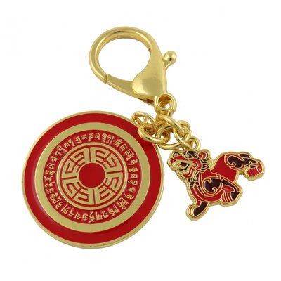 a red and gold keychain with a chinese symbol on the front is shown