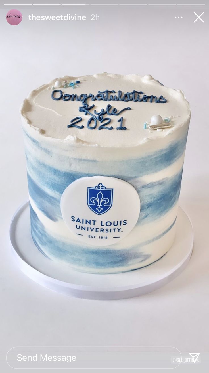 a blue and white striped cake with congratulations written on the top is sitting on a plate