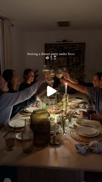 a group of people toasting wine glasses at a dinner table