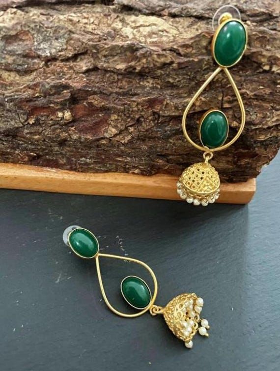 These are purely handmade jumiki earrings in Gold . A gold jumki with emerald green stones . A very unique hand crafted earrings  Available in 1. Ruby red stone & gold jhumka/ jumki 2. Emerald green stone & gold jhumki / jumkha earrings  These are an authentic Indian traditional earrings that could be worn by both traditional and an western attire. This Unique jewellery is designed and crafted at Abi CreatioNzs Abi CreatioNzs is the place for anyone who Is in lookout for a latest trend with an e Green Handmade Jhumkas For Festivals, Heavy Green Earrings For Festive Occasions, Green Earrings For Diwali, Heavy Green Bollywood Earrings, Green Bollywood Chandbali Jhumkas, Bollywood Green Chandbali Jhumkas, Green Latkans Danglers For Celebration, Green Danglers With Latkans For Celebration, Handmade Green Kundan Danglers