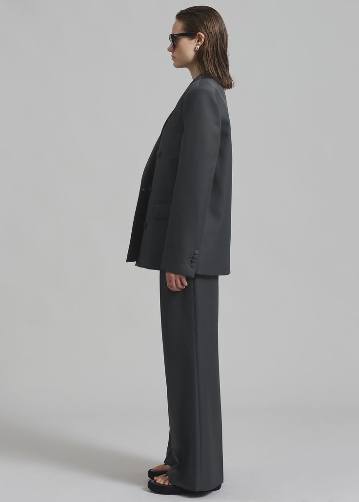 Color: Charcoal Midweight traditional suiting fabric Relaxed boxy silhouette Peak lapels Padded shoulders Single welt breast pocket Button cuffs Front flap pockets Double breasted front button closure Lined 100% Polyester Dry Clean By The Frankie Shop. Imported Tuxedo-style Structured Business Pantsuit, Structured Tuxedo-style Business Pantsuit, Structured Tuxedo Pantsuit For Business, Structured Tuxedo Style Business Pantsuit, Formal Structured Suits With Double Button Closure, Single Breasted Structured Pantsuit For Business, Timeless Business Casual Pantsuit With Welt Pockets, Timeless Pantsuit With Welt Pockets For Business Casual, Single-breasted Structured Pantsuit For Business