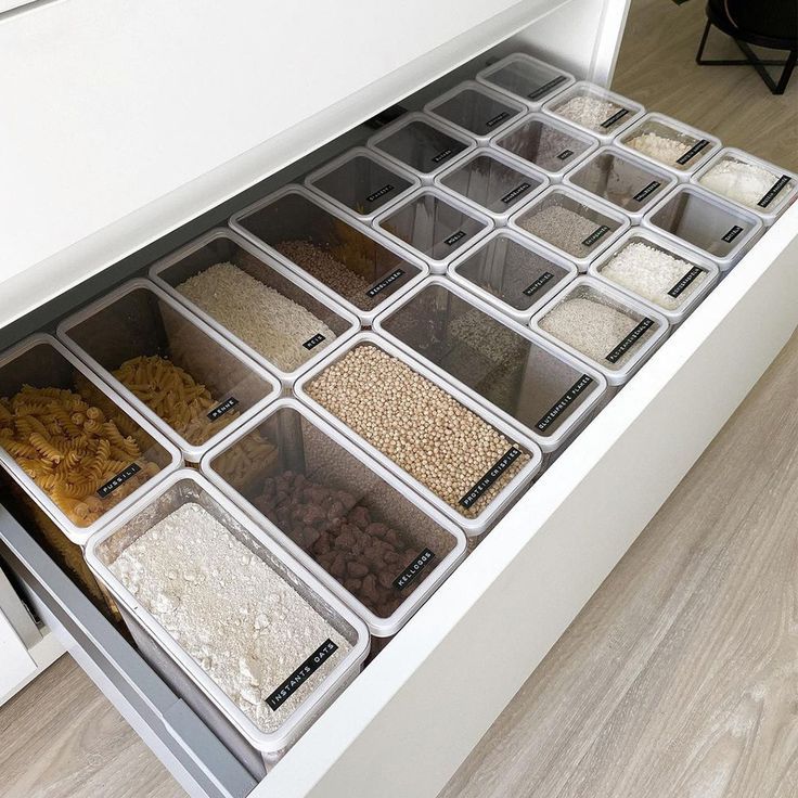 an organized drawer with cereals and grains in it