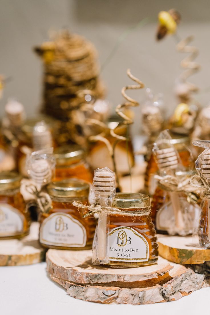 honey jars with labels on them sitting on a table next to stacks of other items