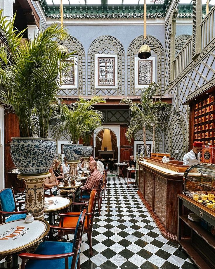 an indoor restaurant with many tables and chairs