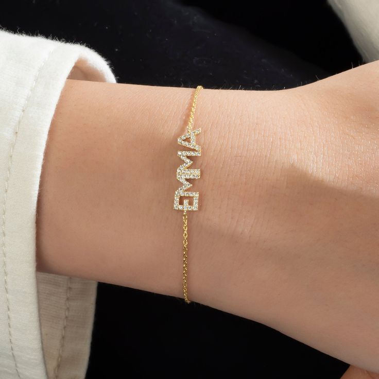 This 14k personalized diamond name bracelet is the perfect gift for the bridal party, someone special, or yourself. * All letters are capital. __________________________________________ M A T E R I A L & L E N G T H Available in 14k Yellow Gold, 14k Rose Gold, 14k White Gold, Sterling Silver Stone: Natural Diamond Thickness: 1.2mm / 0.05" Initials: 6 mm Diamond: 0.15 ct. - 0.40 ct. depending on the name Bracelet length: 6+1 inches (Please let us know if you prefer a different length) Color: G Qu Personalized Diamond Bracelet As Gift, 14k Gold Name Bracelet With Initials, Personalized 14k Gold Name Bracelet With Initials, Dainty Personalized Diamond Bracelet As Gift, Dainty Personalized Diamond Bracelet For Gift, Personalized Fine Jewelry Name Bracelet, Diamond Name Bracelet In White Gold For Gift, White Gold Diamond Name Bracelet As Gift, Diamond Name Bracelet In White Gold As Gift