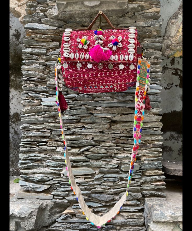 About bag  Indo-gypsy fusion, everyday use hand bag made from Banjara fabrics sourced from Vintage tribal costumes of regions of Rajastan and Gujarat. These are embellished with light catching coins, and intricate bead work tassels. Size - length 15 inches/ width 21 inches Company details:  Company name: Houseoftextile  Contact number: +919784447473  Email id: houseoftextile77@gmail.com  Shipping & custom : Delivery through one of the finest service providers : Skyway, Fedex, UPS  And DHL. Any l Traditional Satchel Beach Bag, Traditional Satchel Bag For Beach, Artisan Embroidered Beach Bag, Bohemian Beach Bag For Festivals, Bohemian Pink Satchel Bag, Bohemian Style Summer Satchel, Bohemian Pink Embroidered Shoulder Bag, Pink Embroidered Bohemian Shoulder Bag, Pink Bohemian Embroidered Shoulder Bag