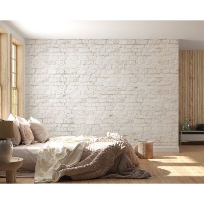 a bedroom with white brick walls and wooden floors