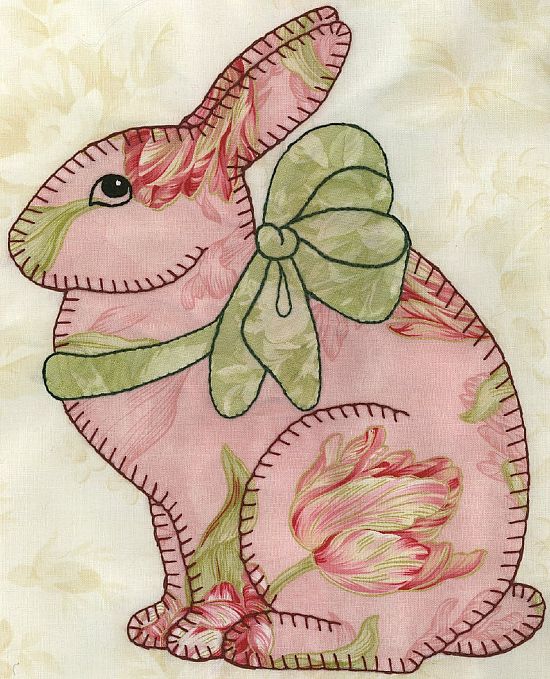 a pink bunny with a green bow on it's back