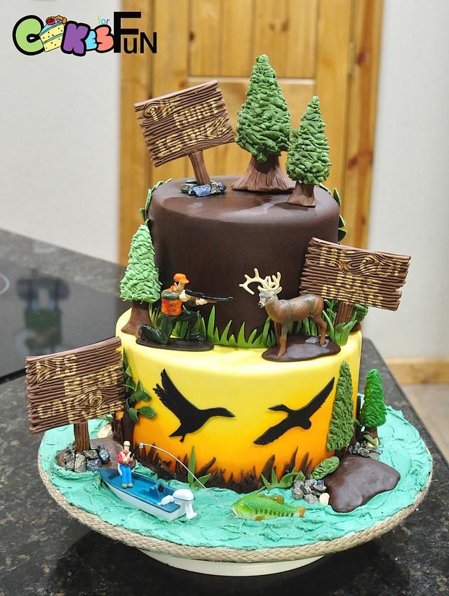 a birthday cake decorated with trees and animals