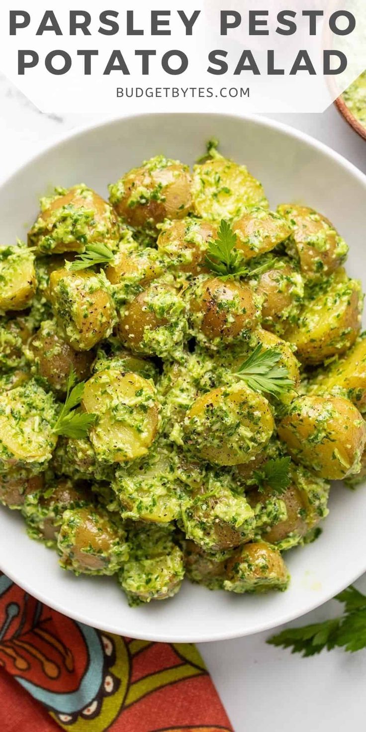 a white bowl filled with pesto potato salad