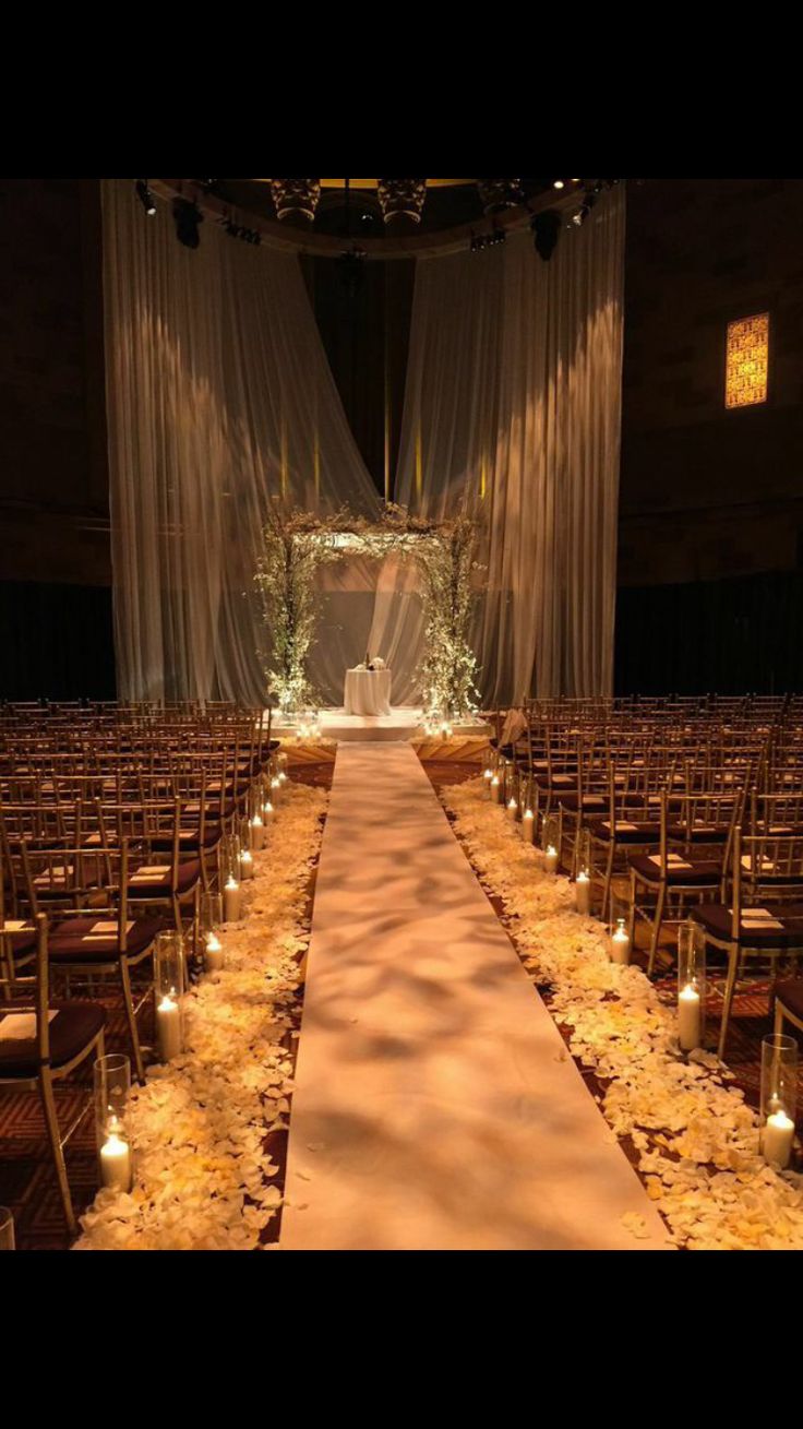 the aisle is lined with candles and flowers