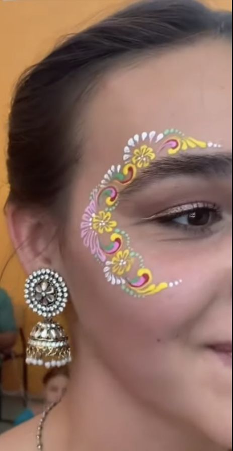 a woman with face paint on her face