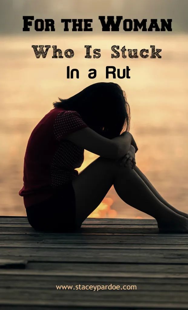 a woman sitting on a dock with her head in her hands and the words for the woman who is stuck in a rut