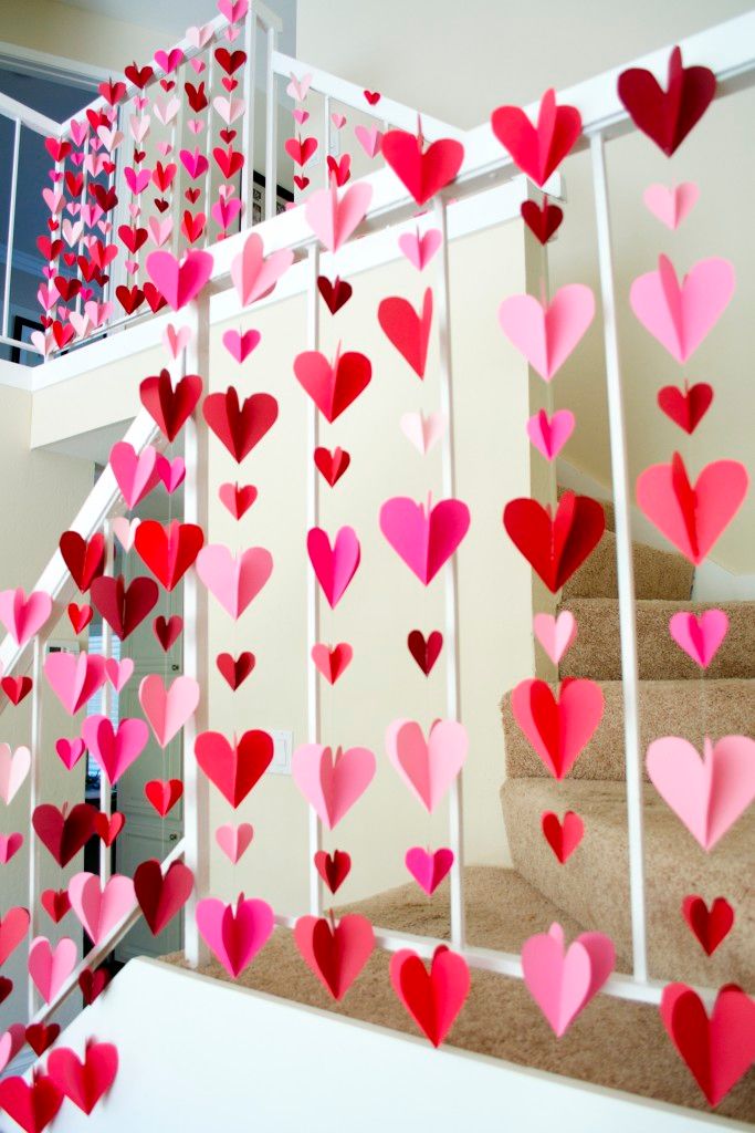 paper hearts are hanging from the banisters in this staircase decorated for valentine's day