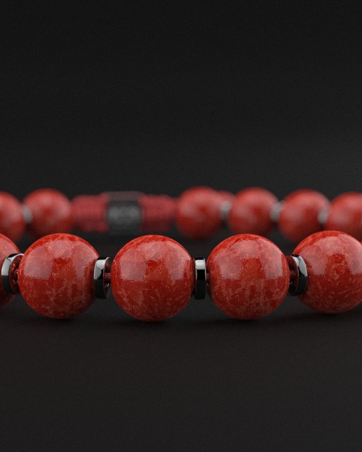 Experience the powerful energy and bold elegance of the Red Coral Jade Bracelet from the Prayer Collection. This stunning piece combines the vibrant red hues of coral jade with a sophisticated design, making it a standout accessory for any occasion. Design and Materials: Red Coral Jade Beads: Featuring smooth 8mm red coral jade beads, this bracelet embodies the striking red tones known for their energizing and protective properties. Gold Plated Cylindrical Spacers: Each jade bead is separated by Luxury Adjustable Red Bracelet, Modern Red Bracelet Jewelry, Luxury Red Beaded Bracelets As Gift, Luxury Red Beaded Bracelets For Gift, Luxury Red Beaded Bracelet For Gift, Red Bracelets With Natural Stones And Round Beads, Red Bracelets With Natural Round Beads, Red Bracelet With 8mm Round Beads, Red Bracelets With Natural Stones