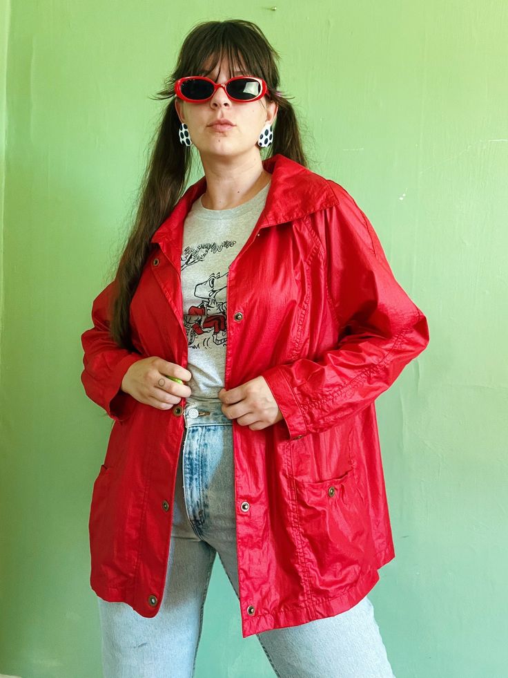 "+ comfy, casual, & colorful vintage eighties windbreaker jacket in an ultra bright & bold shade of red + relaxed, sporty shape with long sleeves, open shoulders, collared neckline, & brass snap front closure (with more snap closures at each pocket & sleeves cuff) + two front pockets at each hip & a small zipper pocket at the right chest + small stretchy elastic insert at the center back of jacket to aid in fit  + 100% nylon ~ feels like the classic lightweight, swishy material with a bit of ref Trendy Oversized Red Outerwear, 90s Spring Outerwear With Relaxed Fit, 90s Style Relaxed Fit Spring Outerwear, Trendy Red Collared Outerwear, Red Relaxed Fit Outerwear For Streetwear, 90s Style Long Sleeve Spring Outerwear, Red Summer Outerwear With Pockets, Trendy Red Windbreaker For Streetwear, Vintage Oversized Outerwear For Summer