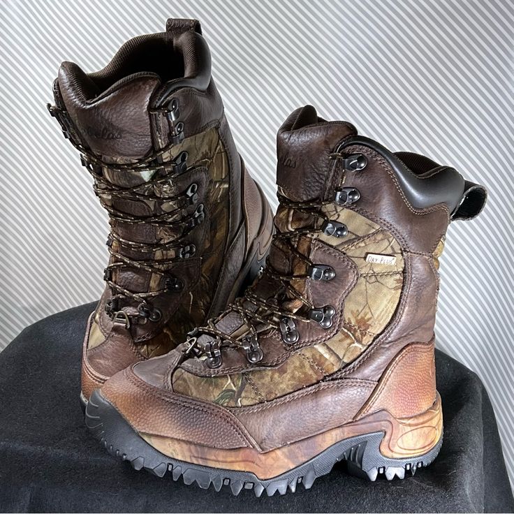 a pair of brown boots sitting on top of a table