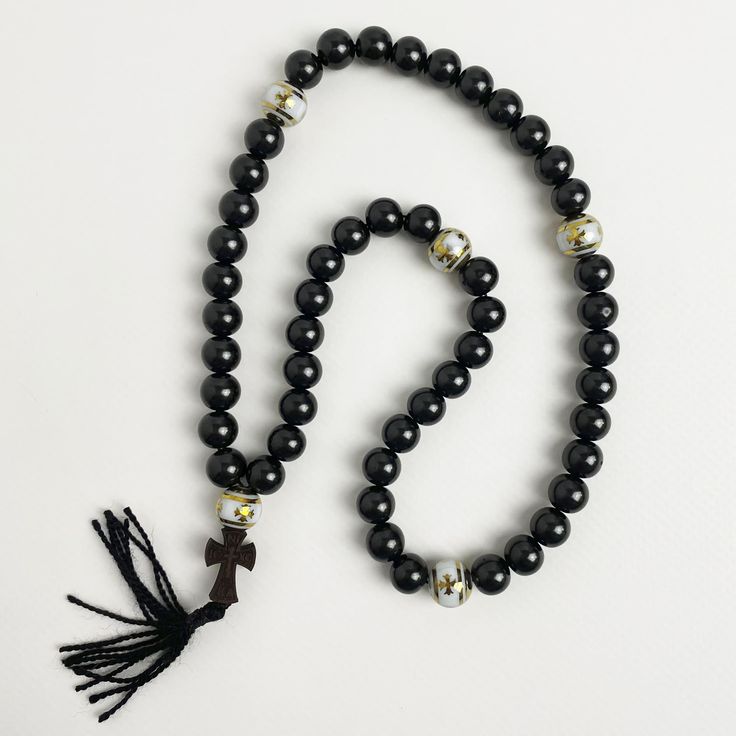 "Orthodox rosary beads are crafted from natural stones known as \"Gagat,\" revered since ancient times for its protective and healing properties. This stone is also known as \"Black Jasper\" or \"Black Amber.\" Additionally, the splitting beads are made from the wood species \"Boxwood,\" recognized for being one of the toughest wood species. Orthodox black rosary will be an amulet and protector of its owner, used for counting the prayers read or other ritual actions, preserving attention and concentration, the task of rhythm, massage nerve endings located on the fingertips, associated with the nervous system of man.  ★ Length of the rosary: 11.8 in (30 cm) ★ Bead diameter: 0.31~0.39 in (8~10 mm) ★ Number of beads: 50+5 pcs (50 gagat beads, 5 boxwood beads) ★ Dimensions of the cross: 0.86 ( Hand-strung Spiritual Beads For Blessing, Spiritual Round Beads Jewelry For Blessing, Spiritual Wooden Beads Jewelry For Blessing, Spiritual Jewelry With Wooden Beads For Blessing, Spiritual Wooden Beads Jewelry For Healing, Handmade Round Beads Mala For Blessing, Handmade Mala With Round Beads For Blessing, Spiritual Rosary Bracelet With 108 Beads As Gift, Spiritual Rosary Bracelet With Round Beads For Meditation