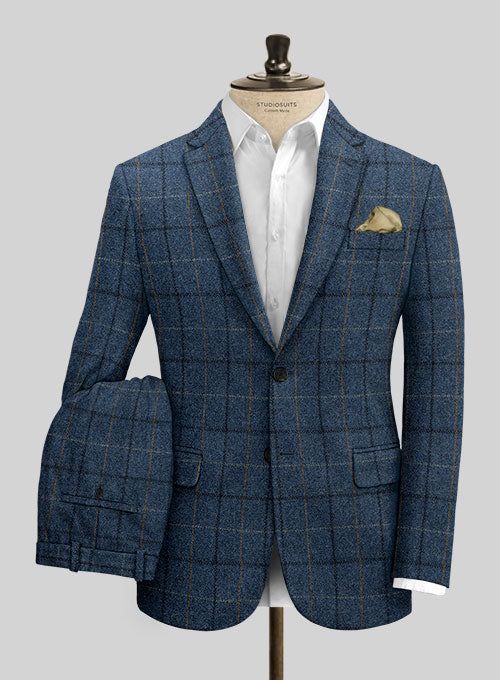 Channel boss vibes everyday with this refined Harris Tweed Gordon Blue Suit to look great in this new season. Crafted from pure wool, the suit is a stylish piece for your next elegant affair with a shade of blue that will help you charm your way through tedious tasks and an impeccable checks design that carries a timeless appeal. The suit will seamlessly blend together with your favorite shirt to create an eye catching ensemble.  Look Includes   Harris Tweed Gordon Blue Fabric  Two Button Jacket Style  Notch Lapel  Horn Royal Black Buttons  Single Vent  Three Cuff Buttons  Two Welted Back Pockets on Trousers   You can change the look during customization if required.  Lining: Viscose, Dry Clean. Tailored Tweed Suits For Business Casual, Blue Tweed Suit For Work, Blue Tweed Suits For Work, Luxury Tweed Suits For Semi-formal Occasions, Luxury Semi-formal Tweed Suit, Tweed Notch Lapel Suit For Business Casual, Business Casual Tweed Suits With Notch Lapel, Blue Tweed Jacket For Business Casual, Luxury Tweed Business Suits