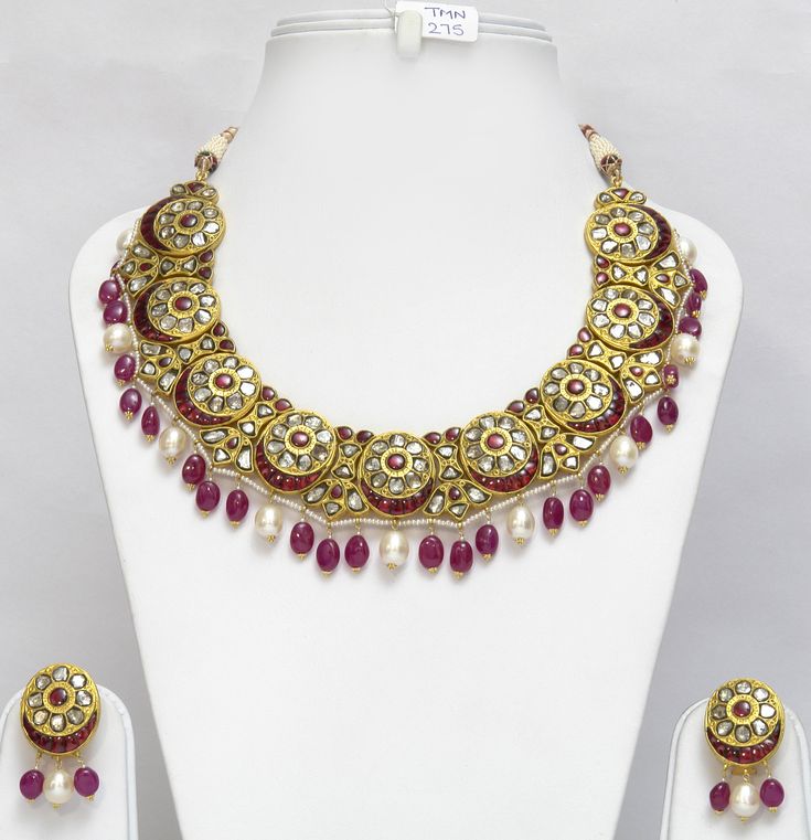 This Antique Necklace is very Beautiful. It is a handcrafted One of a Kind Piece. It is set in 22Kt Gold with Rosecut Diamonds, Ruby, and Pearl. It has Pearl and Ruby Gemstone Beads at bottom of the Necklace and Earring. It is a Perfect Gift for Anniversary, Gift for Mother, Wedding Gift. This Necklace set is a traditional piece Indulge yourself or buy as a gift for a loved one. Details : Gross Weight: 187.590 gms Dimensions : Necklace Length - 11 Inches +Adjustable Dori Center Drop: 43mm (Inclu Kundan Necklace With 17 Jewels, Kundan Temple Necklace With Gemstone, Festive Round Gemstone Bridal Necklace, Festive Round Bridal Necklace With Gemstone, Festive Bridal Gemstone Necklace, Round Kundan Yellow Gold Jewelry, Luxury Kundan Jewelry Sets For Festive Occasions, Yellow Gold Kundan Round Jewelry, 22k Gold Kundan Necklace With Meenakari