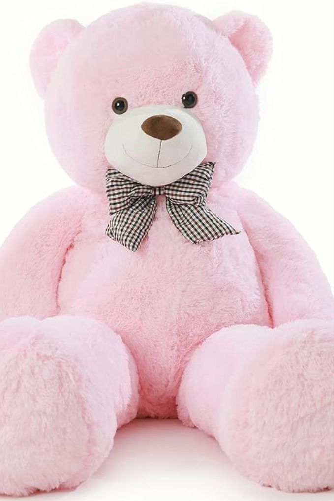 a pink teddy bear with a bow on it's neck sitting in front of a white background