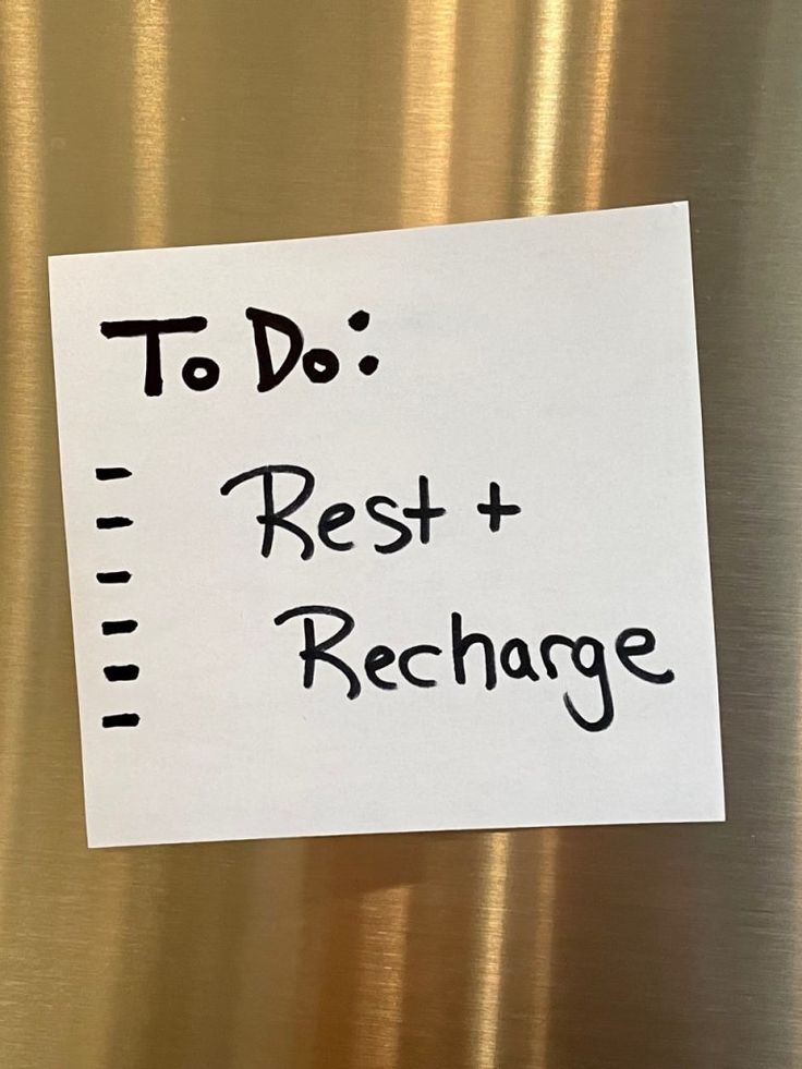 a sign that says to do rest and recharge on the side of a refrigerator