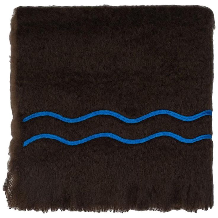 a brown and blue rug with waves on it