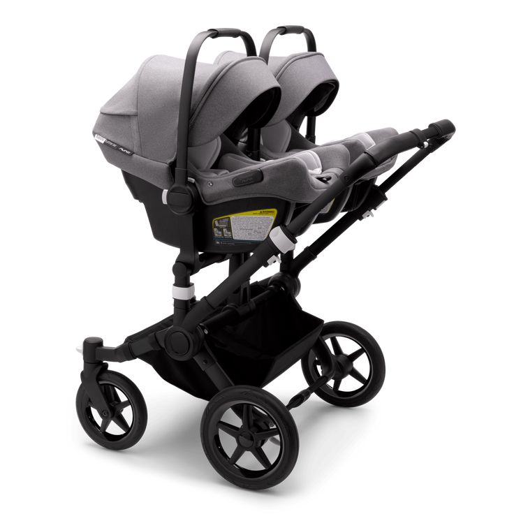 the stroller is black and has two wheels on each side, with one wheel attached to