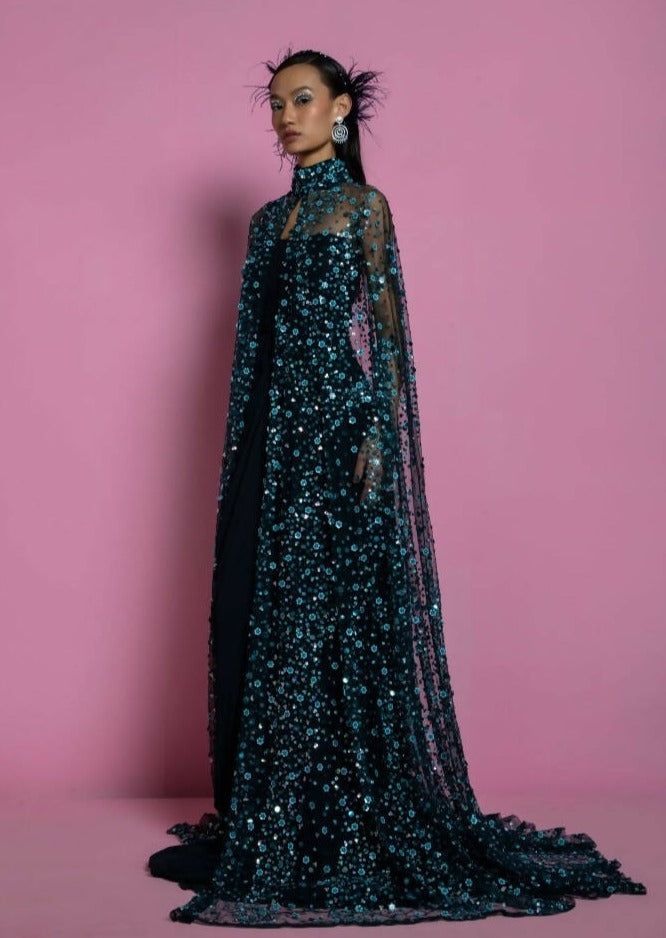 Gorgeous sequined drape neck cape with matching teal georgette gown. Blue Sequin Dress With Cape Sleeves, Festive Gown With Cape Sleeves For Gala, Festive Gala Gown With Cape Sleeves, Reception Gown With Sequins And Cape Sleeves, Festive Gala Evening Dress With Cape Sleeves, Festive Evening Dress With Cape Sleeves For Gala, Embellished Gown With Cape Sleeves, Glamorous Evening Dress With Sequins And Cape Sleeves, Evening Dresses With Sequins And Cape Sleeves