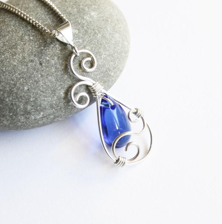 "Graceful and elegant pendant necklace is handcrafted with a beautiful royal blue glass briolette and sterling silver-filled* wire. Pendant comes with an Italian-made, silver filled curb chain with a .925 sterling spring clasp in your choice of length. Simply select your desired length using the drop-down menu to the right, or by leaving a note to seller at checkout. Please see second-to-last photo for exact pendant measurements. Elegantly gift wrapped as shown in last photo, perfectly ready to Blue Teardrop Wire-wrapped Necklace, Blue Wire Wrapped Briolette Necklaces, Blue Briolette Wire Wrapped Necklaces, Hummingbird Pendant, Harpers Ferry, Swirl Earrings, Elegant Pendant, Wire Pendant, Silver Earrings Dangle