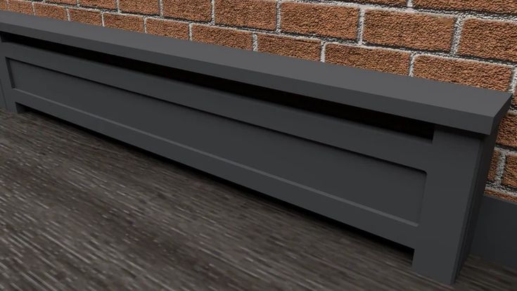 a close up of a brick wall with a black shelf on the floor next to it