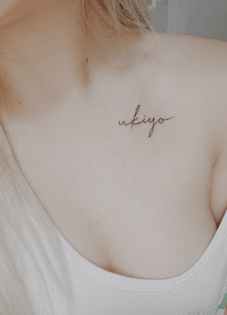 a woman's chest with the word kiyo written in cursive writing