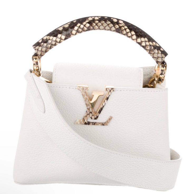 Lv Top Handle 2020 Collection By Nicolas Ghesquiere White Leather Graphic Print Gold -Tone Hardware M Handle & Shoulder Strap Leather Lining And Single Interior Pocket Comes With Dust Bag Est. Measurements Shoulder Strap: 21.75” Handle Drop: 1.5” Height: 5” Width: 7.75” Depth: 3” Faint Scuffs At Exterior, Minor Scratches At Hardware. Excellent Condition Louis Vuitton 2020, Capucines Mini, Nicolas Ghesquiere, White Leather, Mini Bag, Louis Vuitton Bag, Top Handle, Graphic Prints, Leather Straps