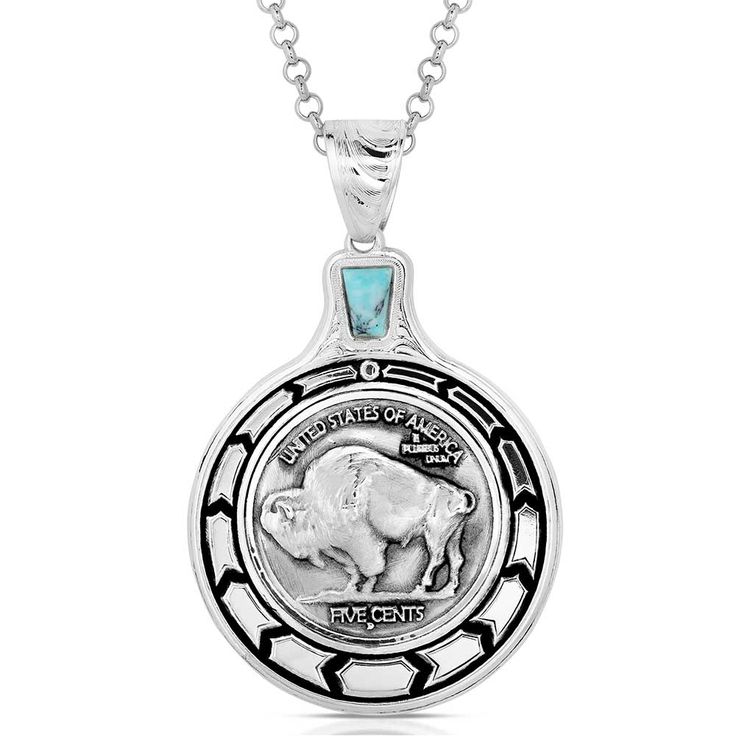 Buffalo Plains Necklace - Made in the USA! Please allow up to 2 weeks to ship Elevate your style with the Buffalo Plains Necklace. This necklace features a unique Buffalo nickel pendant. A detailed Buffalo nickel coin sits in the center of the design. The edge of the pendant features a silver tone chevron pattern contrasted by deep black. A turquoise stone sits just above the pendant, adding a touch of color. This necklace has a 28 inch chain. Stone color may vary. Dimensions Width 1.53 Height 2.49 Length 28 Materials Silver over brass. Crafted turquoise. Paint. Montana Armor to prevent tarnish. Rhodium over brass chain. Symbolic Coin-shaped Collectible Jewelry, Symbolic Coin-shaped Jewelry With Large Pendant, Symbolic Large Coin Pendant Jewelry, Symbolic Collectible Coin Jewelry, Symbolic Jewelry With Large Coin Pendant, Sterling Silver Etched Coin Jewelry, Etched Sterling Silver Coin Jewelry, Etched Coin-shaped Sterling Silver Jewelry, Sterling Silver Concho Pendant Jewelry