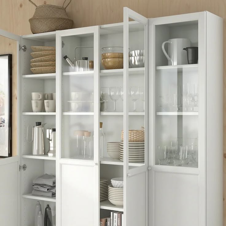 a white cabinet filled with dishes and glasses