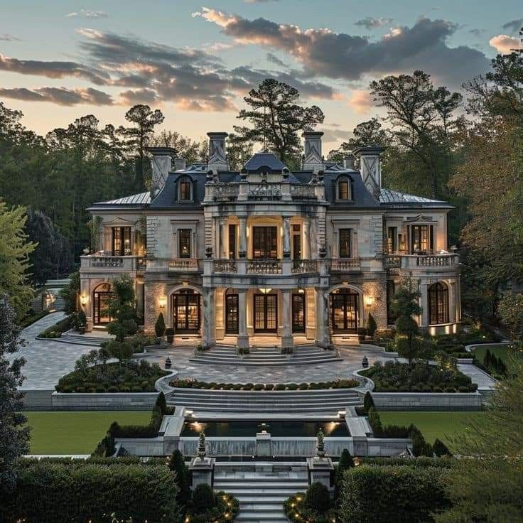 this is an image of a large mansion in the evening time with stairs leading up to it