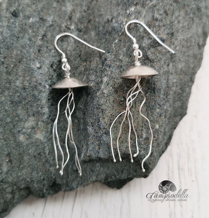 Silver Jellyfish earrings Lovely little silver jellyfish earrings, full of grace and curiosity! Their bodies are crafted from pre 1920 British silver 3 penny coins, each having 5 silver tentacles. Drop approx.  4.5cm Made from 925 Sterling silver wire and 925 pre 1920 solid silver 3 pence coins Each pair slightly different Jellyfish Jewelry, Jellyfish Earrings, Earrings Diy, Coin Jewelry, Dangling Earrings, Handcrafted Earrings, Diy Earrings, Jellyfish, Earrings Silver