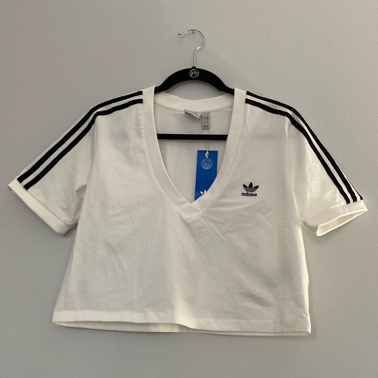 Nwt Adidas White V Neck Cropped Tee. Bust 19”, Length 17.5” White Athleisure T-shirt For Spring, White Sporty Crop Top For Spring, Sporty White Crop Top For Spring, White Athleisure Top With Three Stripes Branding, Adidas Casual Tops With Three Stripes Branding, Adidas Tops With Three Stripes For Spring, Trendy White Top With Three Stripes, Trendy White Tops With Three Stripes, White Short Sleeve Tops With Three Stripes