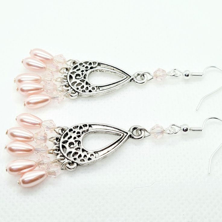 These are handmade luxury earrings. These drop earrings can be worn for any occasion, gift for birthday, for her These chandelier dangle earrings are made with a silver filigree connector with delicate pearl teardrop, bicone or crystal beads with silver plated ear wire. Please choose the colour earring you would like. The earring length is 2.5 inches including the ear wire. The following items cannot be returned  * earrings (this is for hygiene reasons) * customised items  There are other design Feminine Metal Drop Earrings, Silver Filigree Pearl Drop Earrings, Elegant Metal Teardrop Beaded Earrings, Silver Filigree Drop Pearl Earrings, Handmade Feminine Earrings For Gift, Handmade Elegant Metal Crystal Earrings, Handmade Feminine Drop Earrings, Elegant Teardrop Earrings Gift For Her, Silver Beaded Drop Earrings As Gift