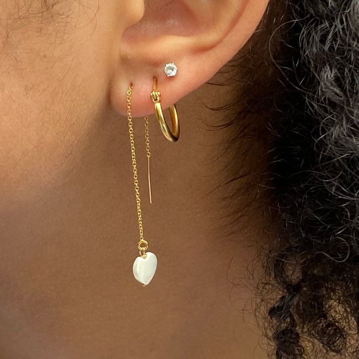 These super cool earrings are versatile and lightweight. They feature a tiny 8mm white mother of pearl hand carved heart that dangles from 3” of 14kt gold filled threader chain including the post. Simply push the post through the pierced hole and pull through to desired length. They come with a rubber stopper so can also be worn as a long dangle post earring once the stopper is put on the post. 14k Gold Filled Threader Earrings As Gift, White Threader Earrings With Adjustable Chain, White Dangle Threader Earrings With Adjustable Chain, White Threader Earrings With Adjustable Chain As A Gift, White Threader Earrings With Adjustable Chain For Gift, White Adjustable Chain Dangle Threader Earrings, White Dainty Drop Threader Earrings, Tarnish Resistant Dangle Threader Earrings As Gift, Dainty Tarnish Resistant Threader Earrings As Gift