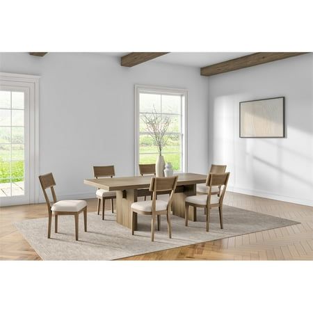 a dining room table with chairs and a rug