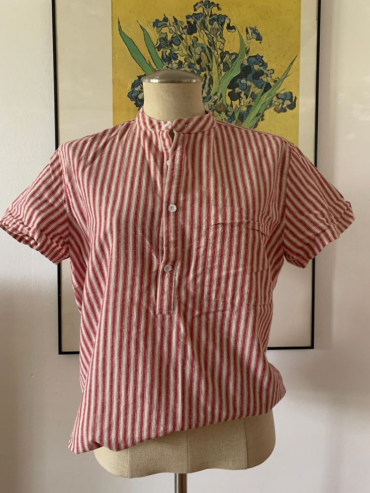 This cute deadstock shirt is a great one to pair with so much. It's a minimalist casual shirt with red and white stripes all over. It has a pocket in the bust and buttons half up. Size Medium (M). No returns. FOLLOW US + Instagram @thriftgathershop Summer Cotton Shirt For Daywear, Collared Cotton Beach T-shirt, Collared T-shirt For Beach With Relaxed Fit, Collared Cotton T-shirt For The Beach, Red Camp Collar Top For Summer, Red Shirt For Summer Daywear, Red Summer Shirt For Daywear, Red Summer Daywear Shirt, Summer Relaxed Fit T-shirt For Daywear