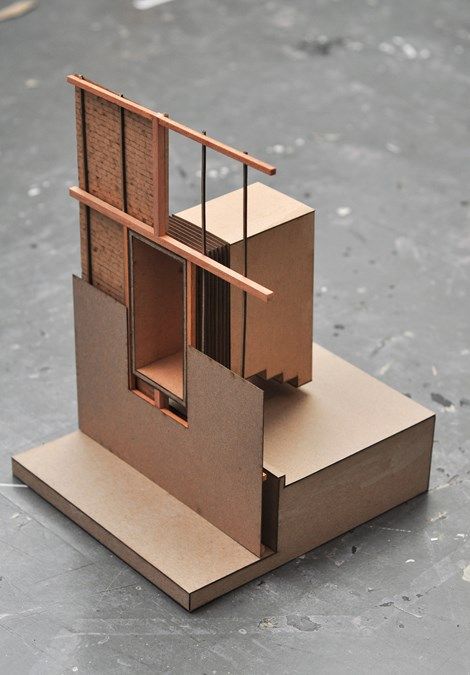 a cardboard model of a house on top of a piece of cardboard with the door open