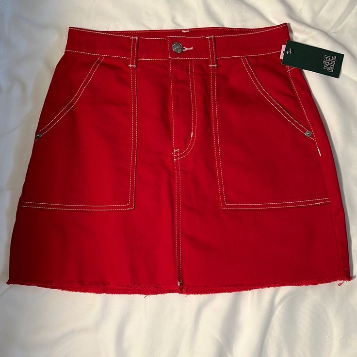 Red Denim Mini Skirt Red Spring Skirt With Pockets, Red Skirt With Pockets For Spring, Red Cotton Lined Skirt, Red Cotton Mini Denim Skirt, Red Cotton Bottoms With Frayed Hem, Red Mini Skirt With Pockets, Red Casual Mini Skort, Casual Red Mini Skort, Red Casual Mini Length Skort