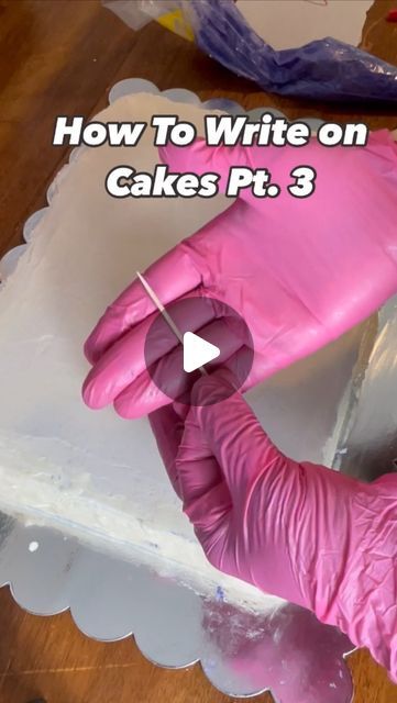 a person wearing pink gloves and holding a knife in front of a cake with the words how to write on it