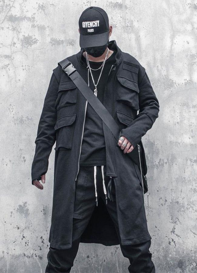 Discover the Techwear Long Coat - the epitome of style and innovation for the modern urban dweller. Imagine walking down the city streets, commanding attention from everyone around you. The Techwear Long Coat exudes a futuristic and intimidating aura that will leave a lasting impression on anyone who sees you. With its oversized silhouette, this coat is perfect for those who want to stand out. This black, oversize coat is designed with Japanese streetwear in mind and is the perfect addition to any fashion-forward wardrobe. Not only is this coat stylish, but it is also practical. With four big cargo pockets on the front and two large pockets with straps on the back, you'll have plenty of space to store your essentials. The tactical and technical aspect of the garment adds to its unique desi Cloak Black, Spring Windbreaker, Cargo Jacket Mens, Techwear Jacket, Apocalyptic Clothing, Tactical Jacket, Streetwear Hip Hop, Clothing Streetwear, Punk Rave