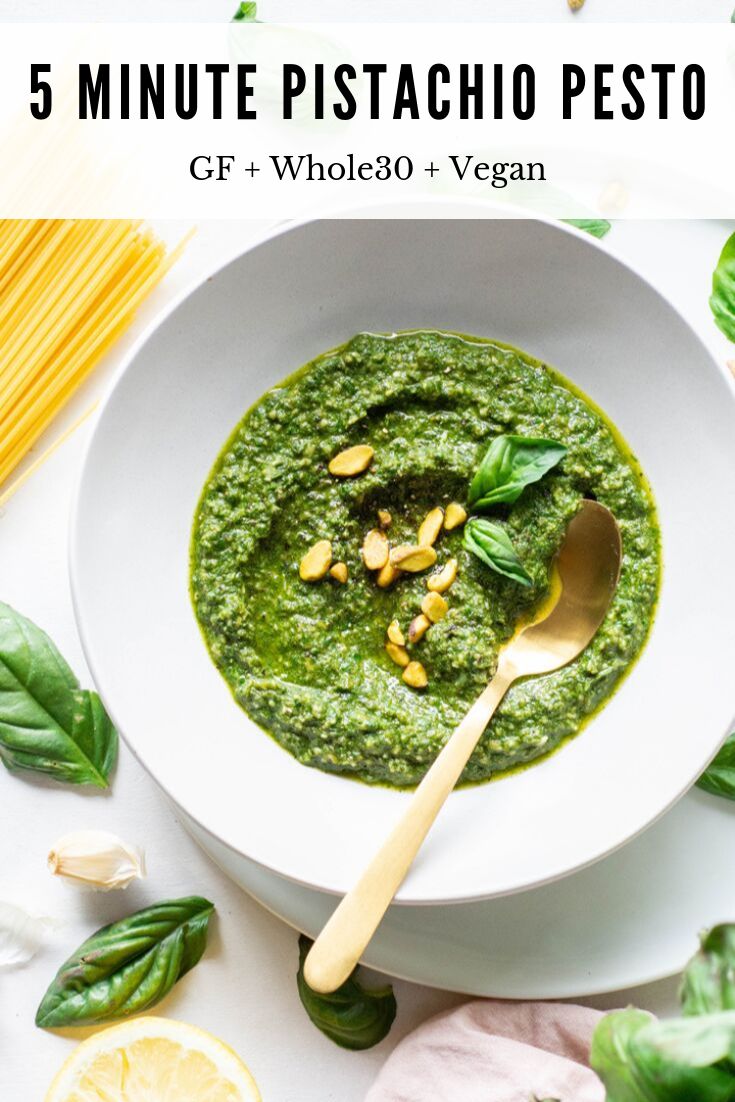 a white bowl filled with pesto and topped with nuts