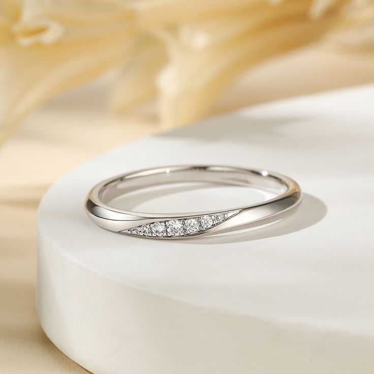 Simply and chic, this band is a clever accessory you will love. Featuring white stones, this band is an elegant symbol of your marital commitment. Buffed to a brilliant luster, this comfort-fit wedding band  will make your vows shine.Carat Weight: 0.086 ctStone Size: 1.1,1.3,1.5 mmStone Type: Jeulia® StoneNumber of Stones: 5 Stone Color: Diamond WhiteStone Shape: RoundWeight: 1.6 gWidth: 1.8 mmHeight: 1.8 mmThickness: 1.1 mmMaterial: 925 SilverPlating Color: Silver Silver Wedding Diamond Ring With Tension Setting, Minimalist Half Eternity Diamond Ring For Formal Events, Minimalist Half Eternity Band For Formal Occasions, Minimalist Diamond Bands For Anniversary, Minimalist Diamond Anniversary Bands, Minimalist Wedding Diamond Ring With Accents, Minimalist Formal Half Eternity Band, Minimalist Diamond Eternity Band For Formal Occasions, Elegant Sterling Silver Eternity Band With Diamond Accents