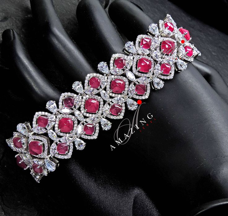 Silver Swarovski Glass Filled Ruby Bracelet |Cubic Zirconia Bracelet |Contemporary Bracelet |925 Silver Bracelet |Bridal Jewelery| 18K Plated | Statement Jewelery Material : Silver Gemstone: Swarovski Cubic Zirconia Stones, Glass Filled Rubies Stone colour: White Primary colour: Gold Closure : Box Lock Bracelet length: 165mm Bracelet width : 10mm Silver Intricate, hand crafted, Pure Silver Swarovski Bracelet, studded with high quality Cubic Zirconia Stones , made in 92.5 silver with 18ct dual go Formal Crystal Bracelets With Stones, Cubic Zirconia Gemstone Bracelet For Parties, Exquisite Cubic Zirconia Gemstone Bracelets, Formal Cubic Zirconia Bracelets With Stones, Formal Crystal Bracelet With Stones, Crystal Gemstone Bracelets For Wedding, Formal Cubic Zirconia Stone Bracelet, Luxury Cubic Zirconia Bracelets With Stones, Dazzling Bracelets With Elegant Design For Formal Occasions