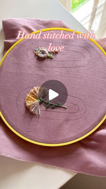 a video demonstrating how to make a hand - stitched cloth love sign with flowers